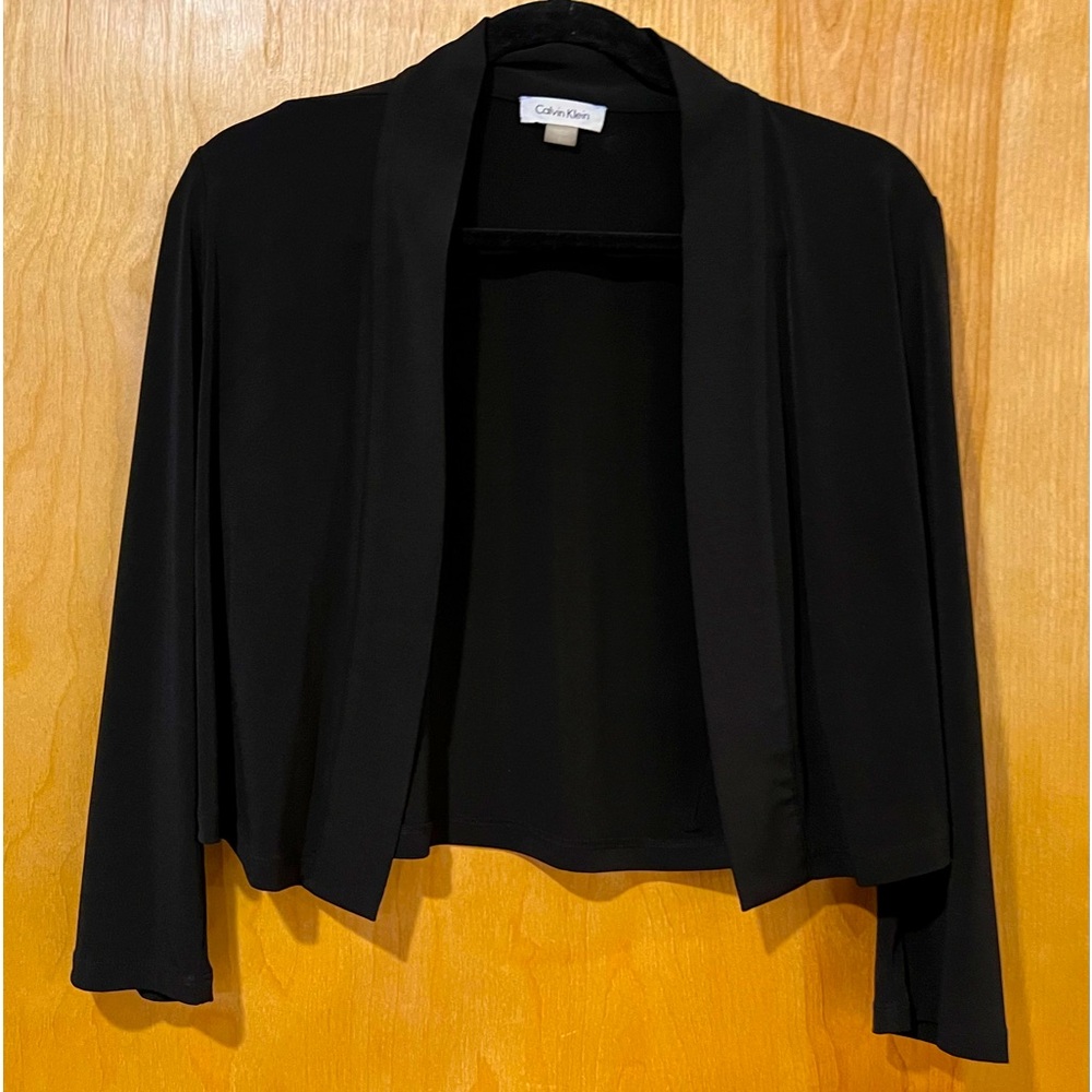 Large Calvin Klein solid black jacket with long sleeves.